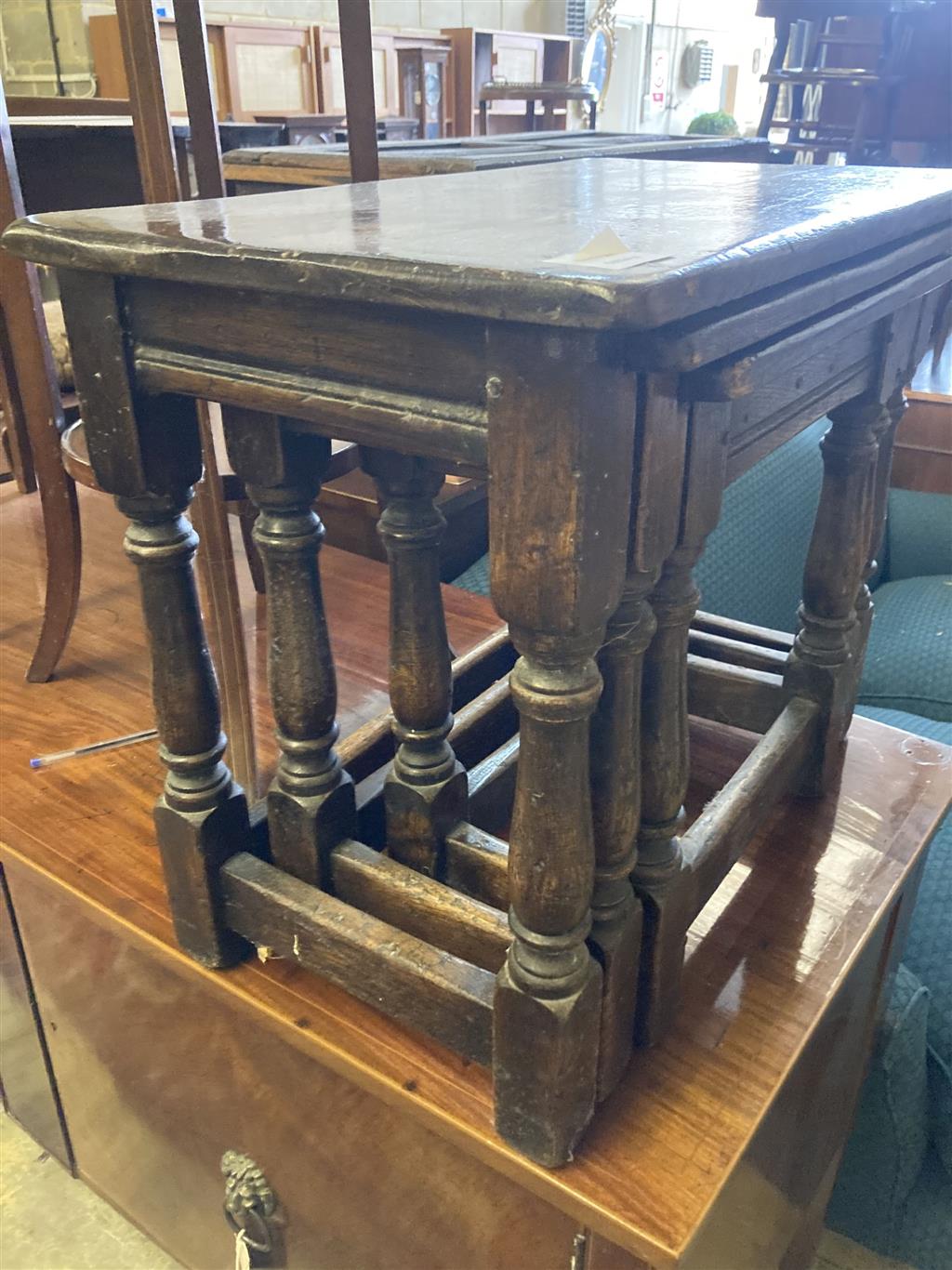 A nest of three 17th century style rectangular oak tea tables, width 61cm, depth 34cm, height 48cm